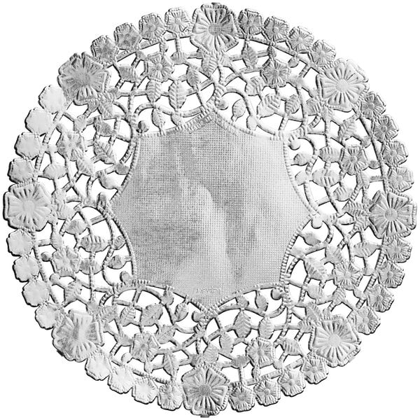 A white doily with a silver pattern on a white plate.