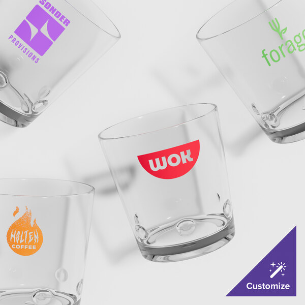 A close-up of a GET Loft plastic rocks glass with a logo on it.