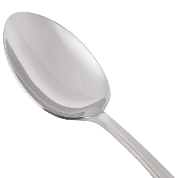 A Libbey stainless steel serving spoon with a silver handle.