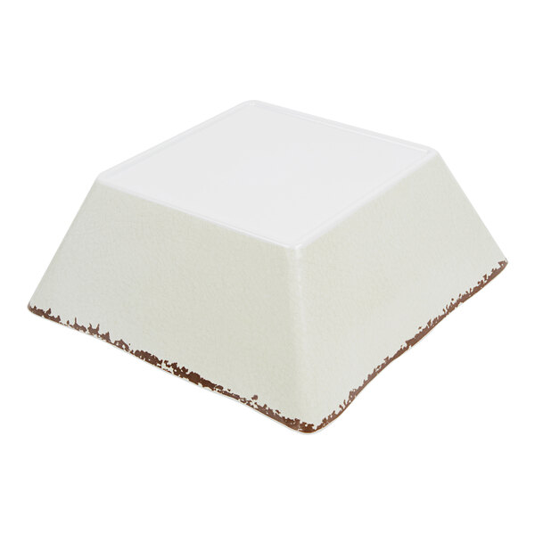 An American Metalcraft white square melamine serving bowl with brown edges.
