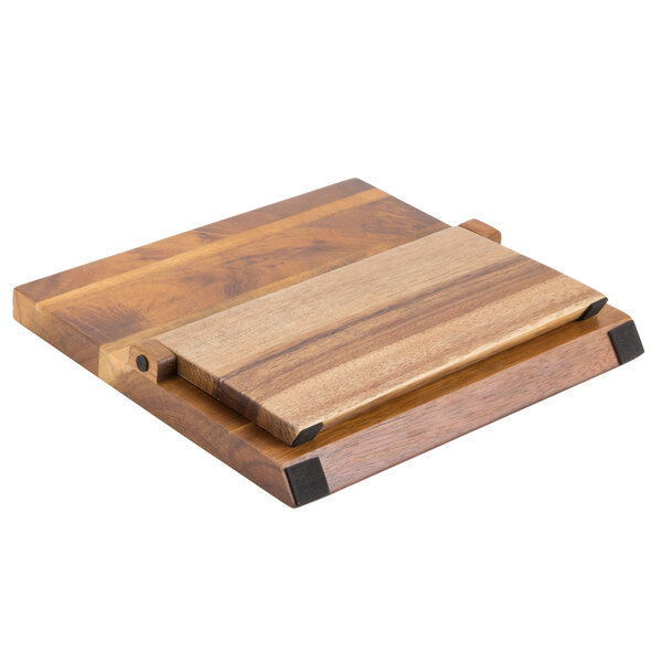 A Mercer Culinary Genesis acacia wood cutting board with a metal clip.