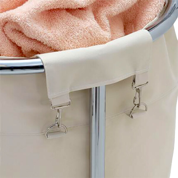 A white laundry basket with a pink towel inside.