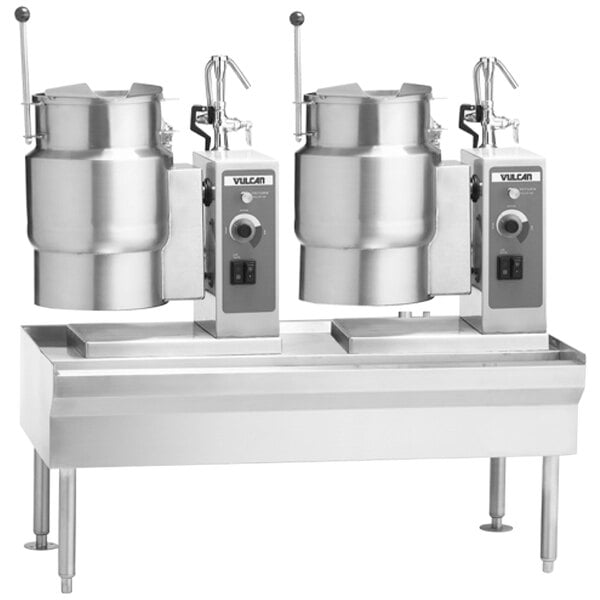 A Vulcan metal table with two electric steam kettles on it.