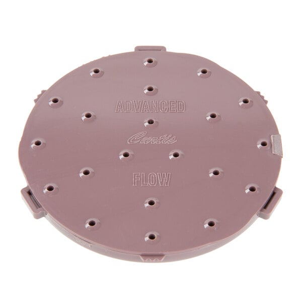 A purple circular plastic Curtis Advance Flow sprayhead with 21 holes.