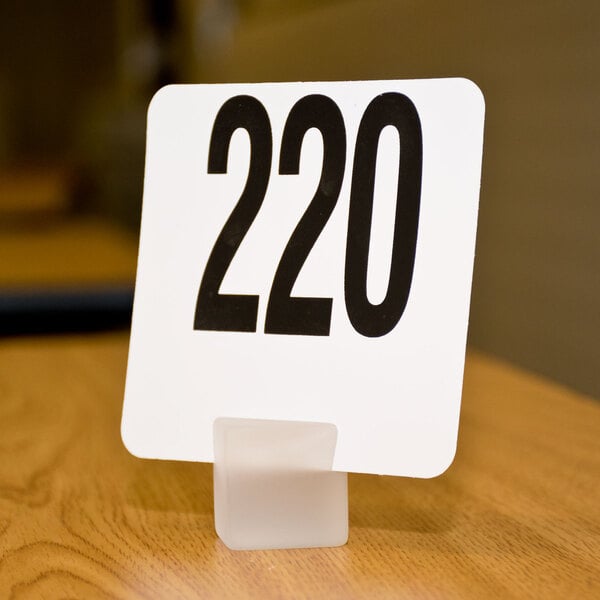 An American Metalcraft frosted white acrylic cube card holder with a black number 200 on it.