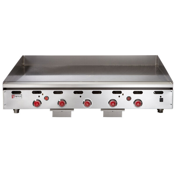 A Wolf liquid propane countertop griddle with red knobs.