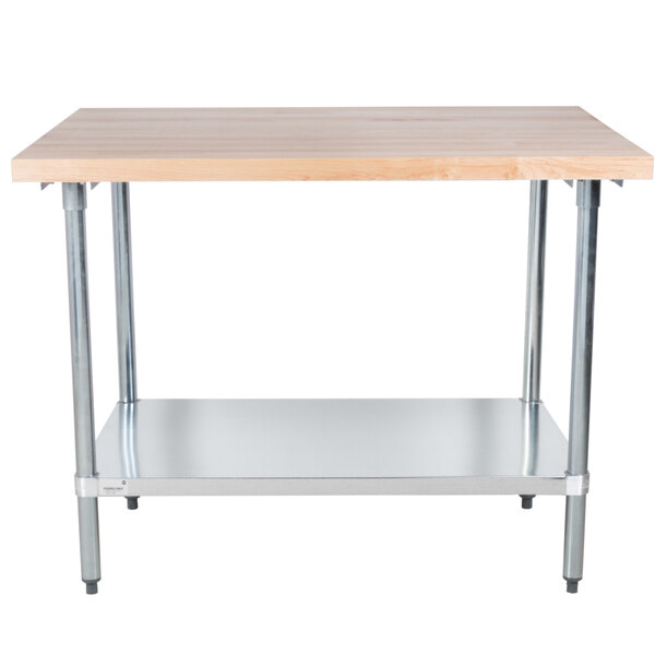 An Advance Tabco wood top work table with a galvanized base and undershelf.