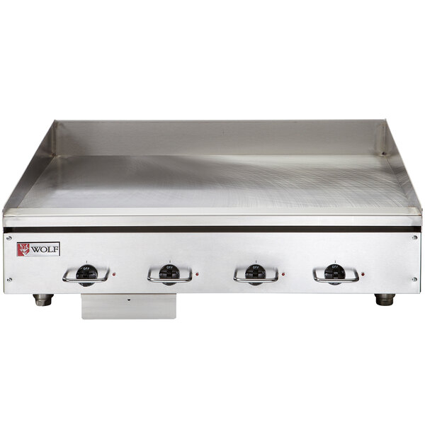 A close-up of a Wolf stainless steel countertop griddle.