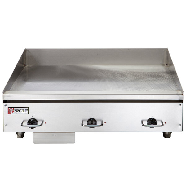 A Wolf stainless steel electric countertop griddle with thermostatic controls.