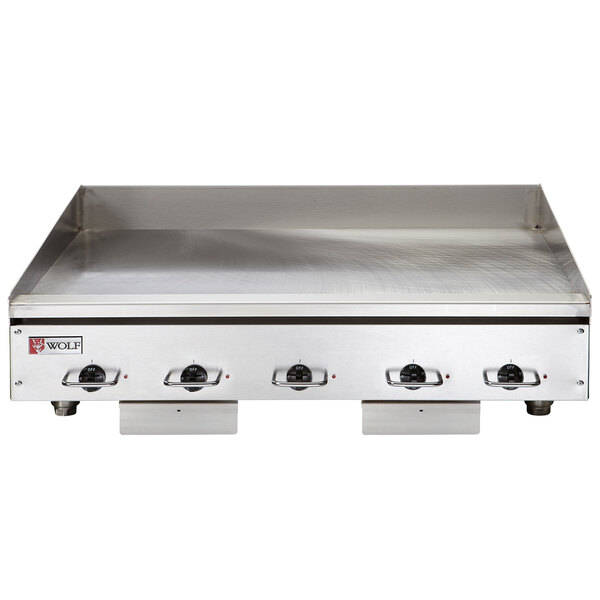 A close-up of a Wolf stainless steel electric countertop griddle.