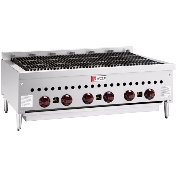 A Wolf stainless steel liquid propane gas charbroiler with red knobs on a counter.