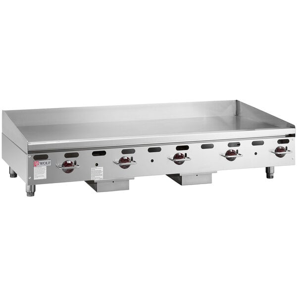 A Wolf stainless steel gas countertop griddle with manual controls.