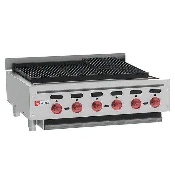 A Wolf by Vulcan stainless steel gas countertop charbroiler with red knobs.