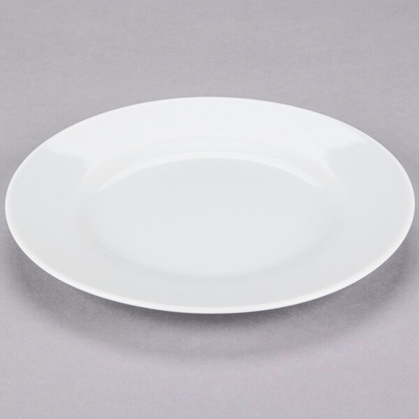A 10 Strawberry Street Classic White porcelain salad/dessert plate with a rim on a gray surface.