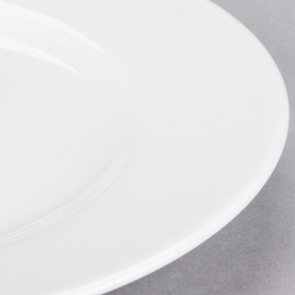 A close-up of a 10 Strawberry Street Classic White porcelain salad/dessert plate with a white rim.