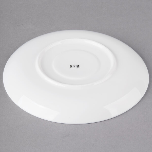 A white round porcelain saucer with black text that says "m"