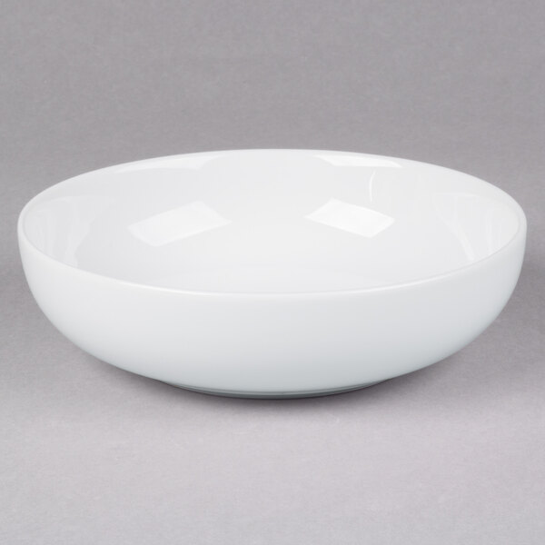 A 10 Strawberry Street classic white porcelain pasta bowl on a gray surface.