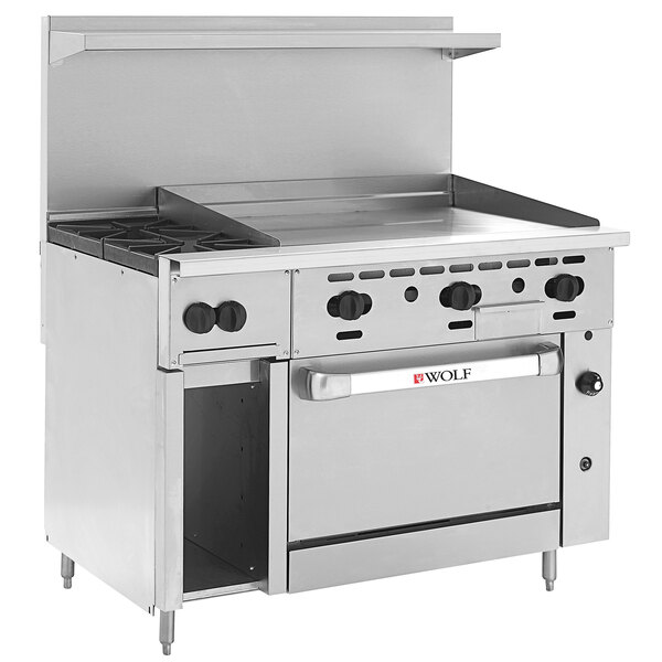 A large stainless steel Wolf commercial range with 2 burners, a griddle, and a convection oven.