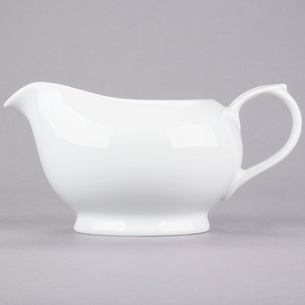 A white porcelain gravy boat.