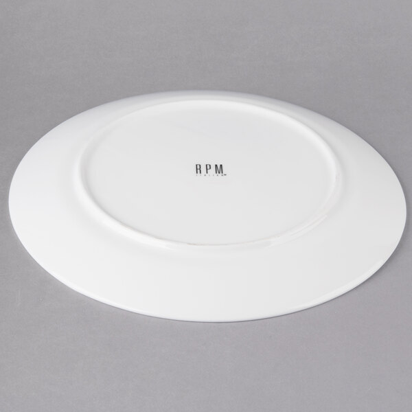 A white 10 Strawberry Street porcelain dinner plate with black text that says "Ricard"