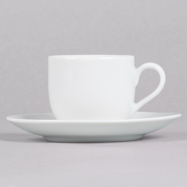 A 10 Strawberry Street white porcelain espresso cup and saucer with a white surface.
