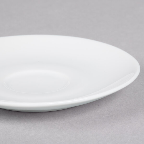 A 10 Strawberry Street white porcelain saucer with a small rim.