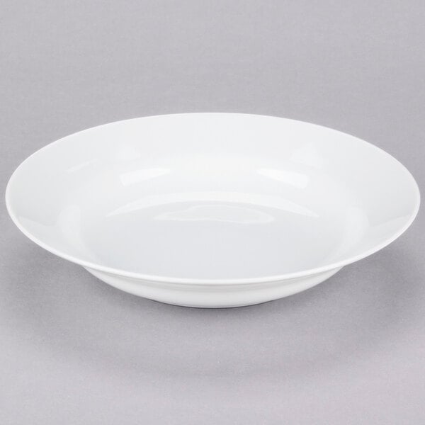 A 10 Strawberry Street Classic White porcelain soup bowl on a gray surface.