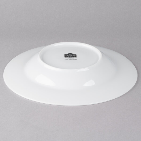 A white porcelain soup bowl with a black rim.