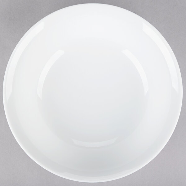 A white bowl on a white surface.