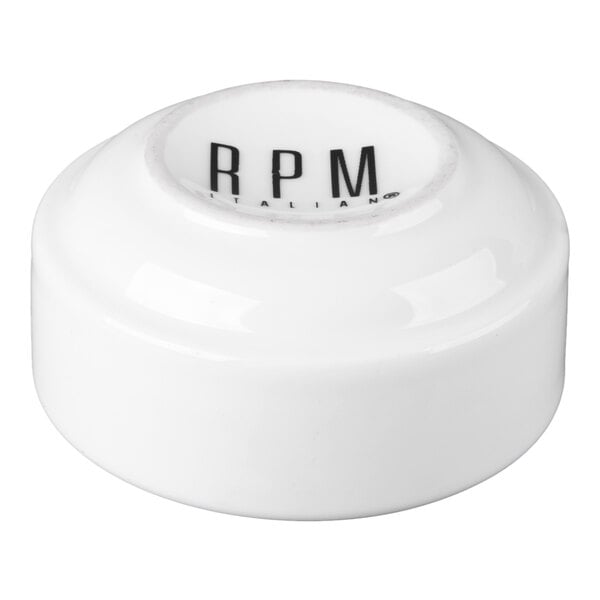A small, white porcelain stackable ramekin with 'RPM' printed on the inside.