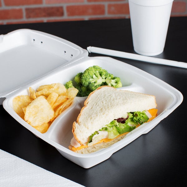 A sandwich with lettuce and cheese in a white foam container.