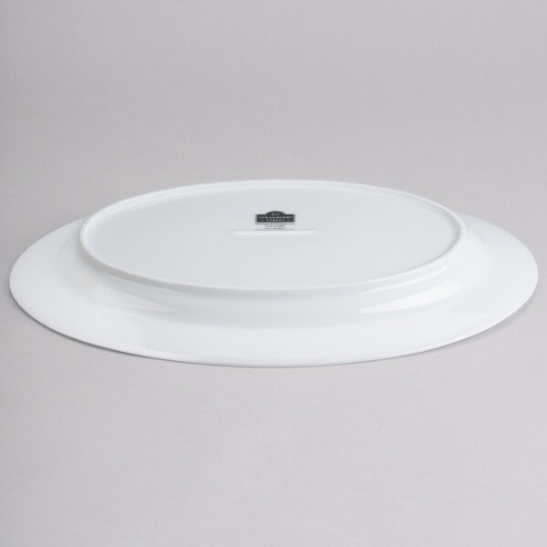 A white oval porcelain platter with a logo on it.
