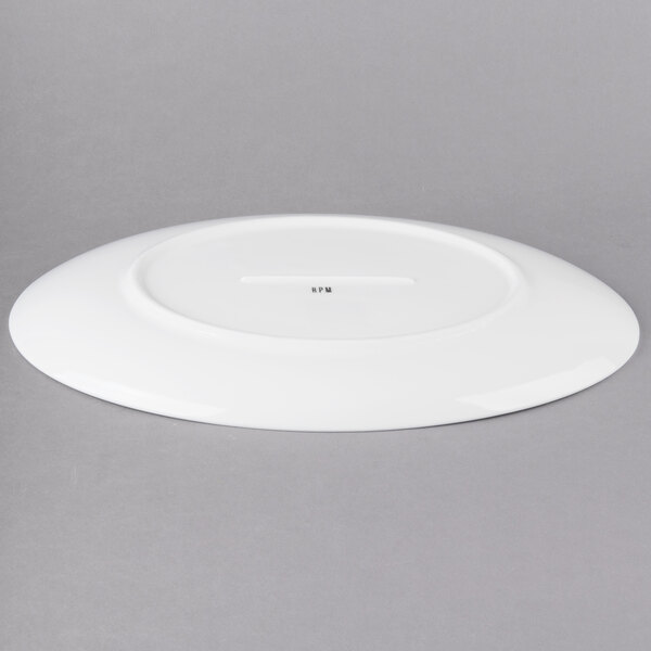 A white oval porcelain platter with a hole in the middle.