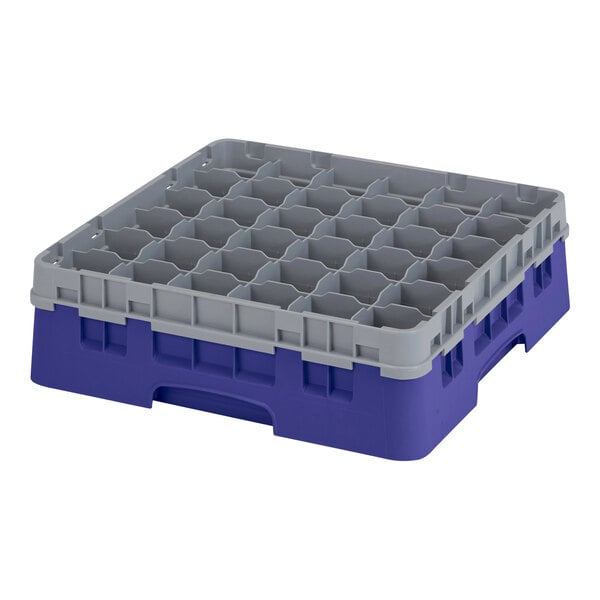 A navy blue plastic Cambro glass rack with small compartments.