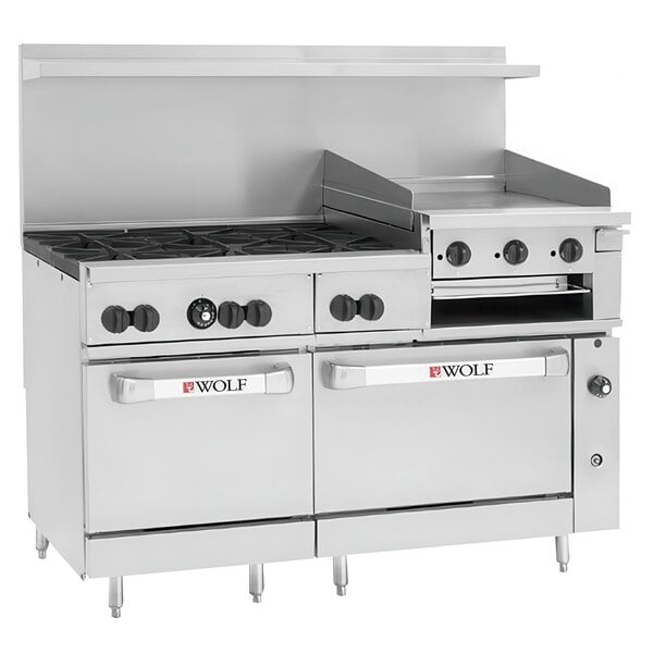 A large stainless steel Wolf commercial gas range with 6 burners, a griddle, and 2 ovens with black knobs.