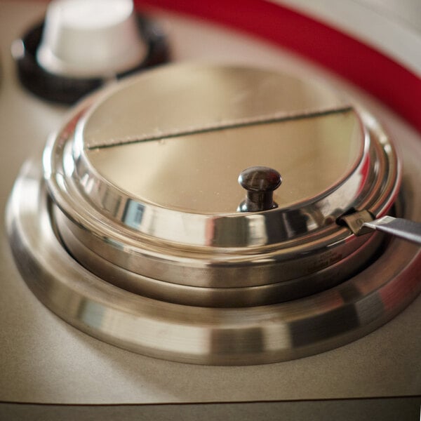 A close up of a Vollrath stainless steel decorative ring.