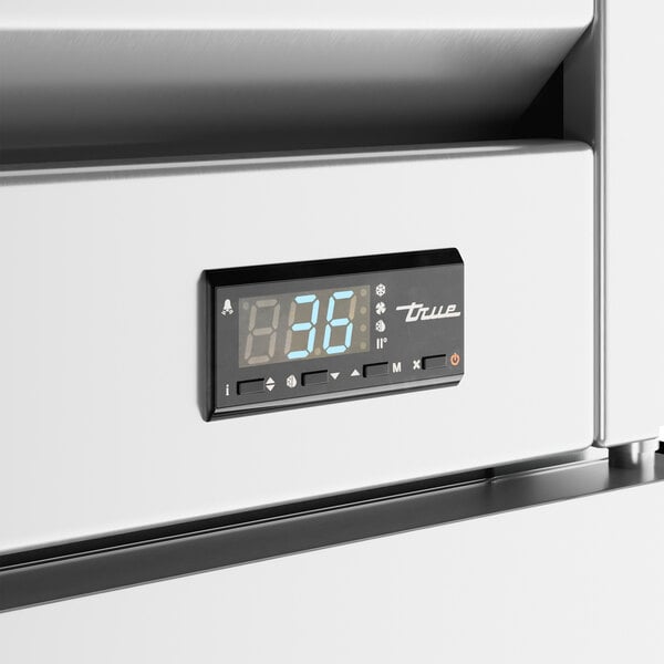 The digital display on a white True reach-in refrigerator.