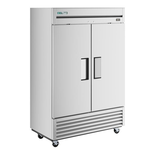 A stainless steel True reach-in refrigerator with black handles on wheels.