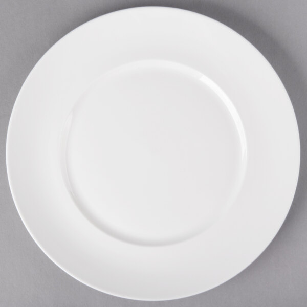 A 10 Strawberry Street white porcelain luncheon plate with a white rim on a gray surface.