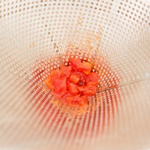 A Vollrath Coarse China Cap Strainer filled with a red sauce.