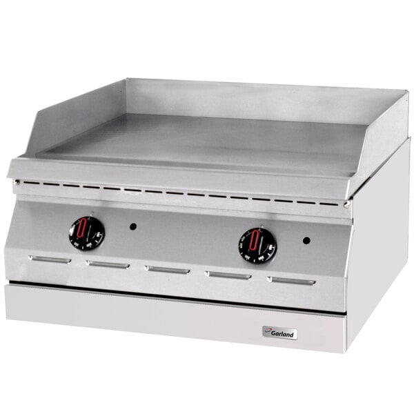 A Garland stainless steel electric countertop griddle with black and red dials.