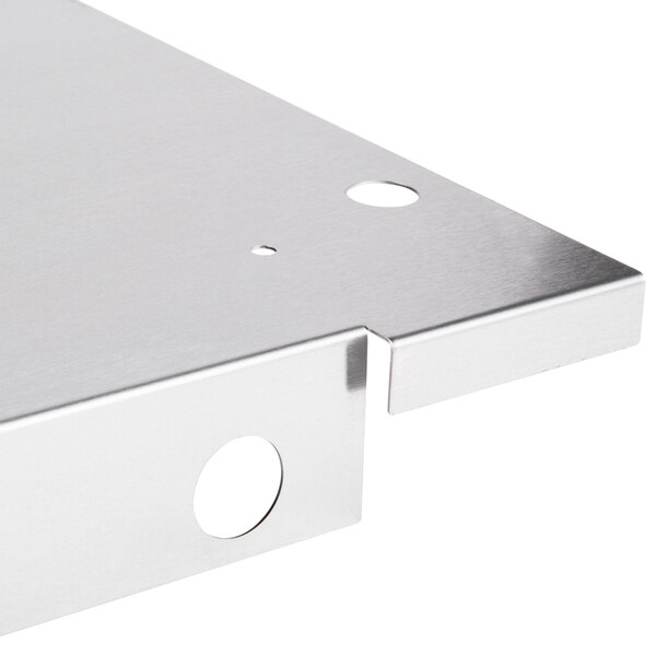 A Wolf stainless steel bottom panel with holes.