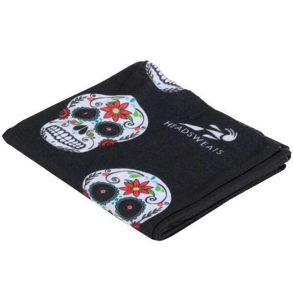 A black cloth headband with skulls on it.
