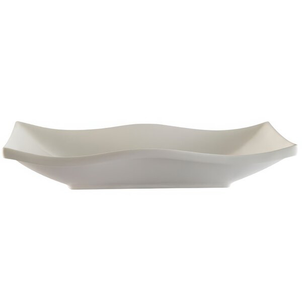 A white rectangular porcelain platter with wavy edges.