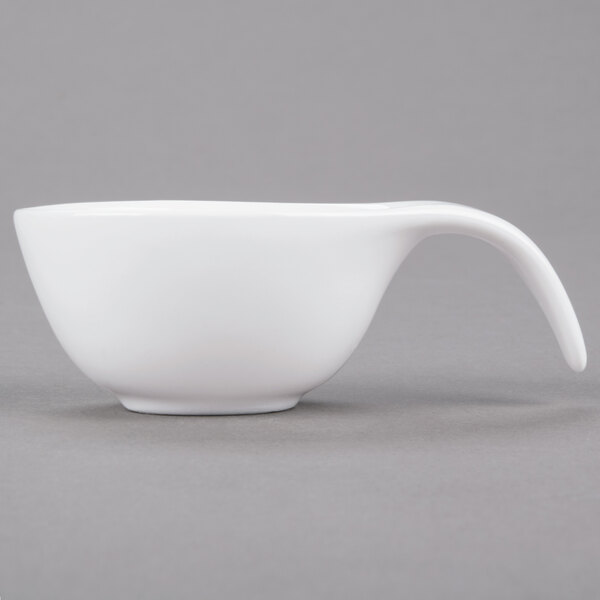An Arcoroc porcelain spoon with a white bowl and handle.