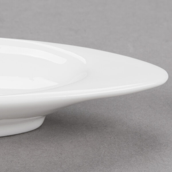 An Arcoroc porcelain dish with a small rim on it.