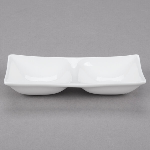 A white rectangular porcelain dish with two compartments.