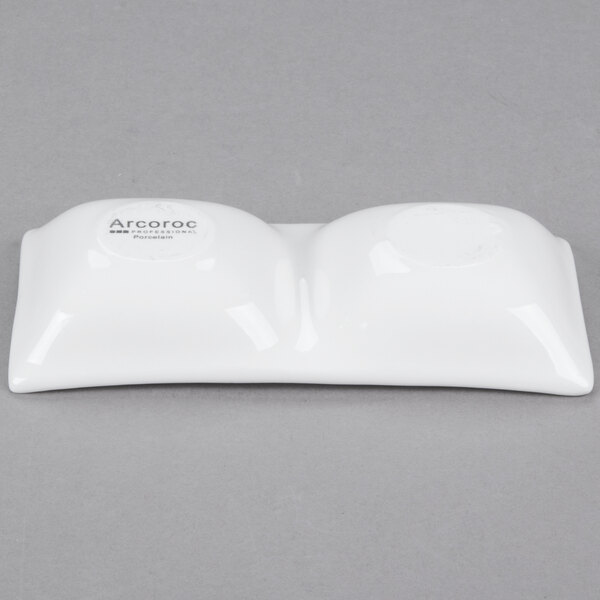 A white porcelain dish with two compartments.