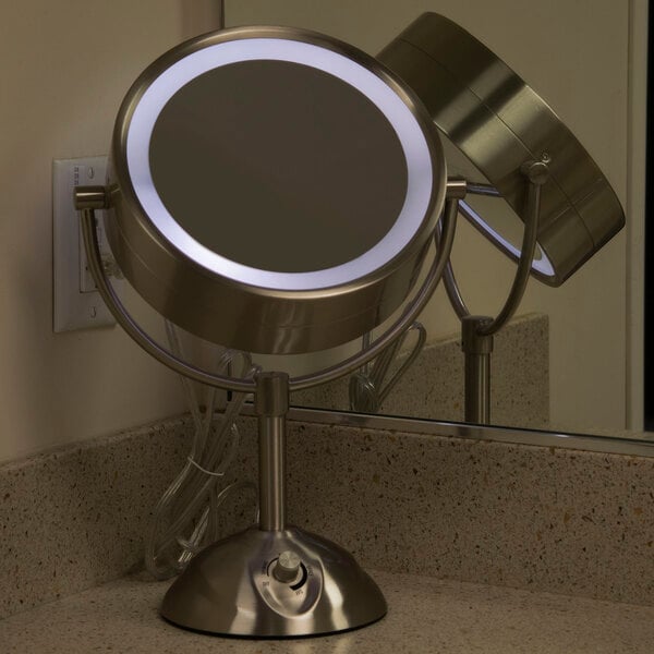 A Conair freestanding vanity mirror with lights on it.