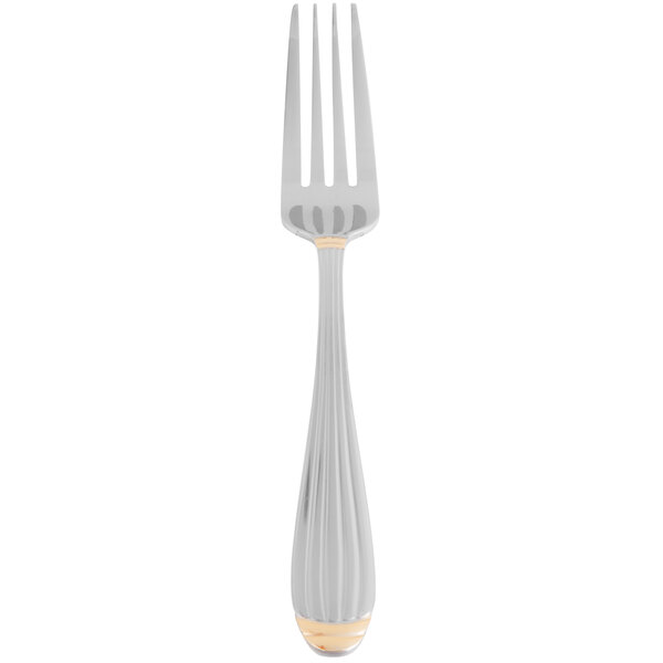 A silver fork with gold trim.